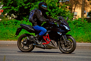 Fototapeta na wymiar motorcycle racer driving at high speed on highway