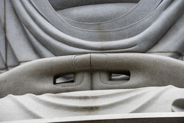 Closeup of sitting & peaceful giant Buddha statue inside Hill of the Buddha, Buddhist shrine at...