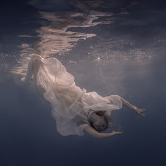 Woman in a white dress under water