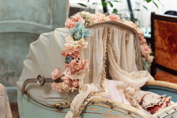 Vintage doll stroller , antique Retro cart dolls on wall background. Holiday greeting card concept