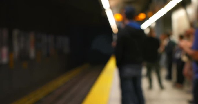 Commuters waiting for train on subway platform 