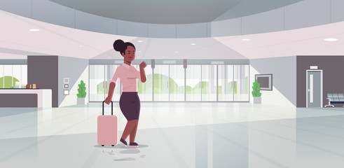 businesswoman with luggage modern reception area african american business woman holding suitcase standing in lobby contemporary hotel hall interior flat horizontal full length