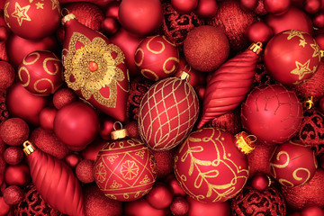 Red and gold Christmas tree bauble decorations forming an abstract background. Traditional theme with symbols for the holiday season.