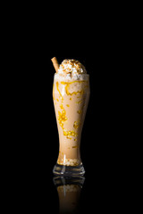 banana milkshake with cream on black background