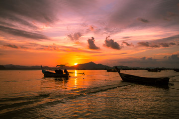 Fototapeta na wymiar Silhouette of beautiful sunset with fishing boat