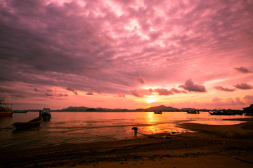 Silhouette of beautiful sunset with fishing boat