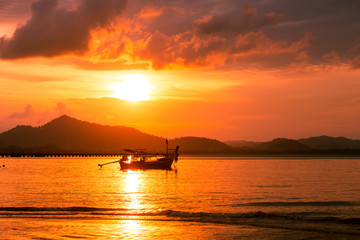 Silhouette of beautiful sunset with fishing boat