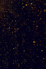 Glitter abstract background shiny particles golden dust flow