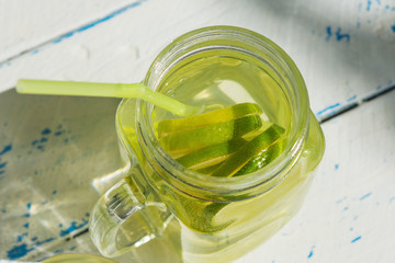 Mason jar of homemade lemonade on a rustic wooden background. Close up. Selective focus.