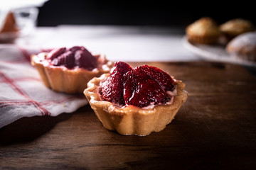 Cupcakes with strawberries, sweet dessert. Mini tarts with strawberries.