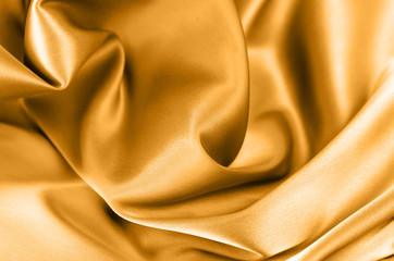 Background from satin fabric of golden color.