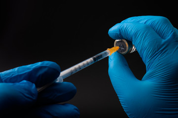 Insulin shot, flu jab or treat sickness with an injection concept theme with doctor or nurse hands...