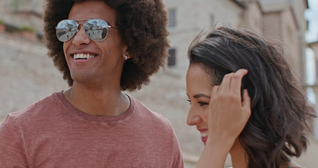 Romantic couple smiling caressing feeling free and happy to the main square in rural town of...