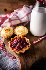 Muffins with filling. Mini tarts with strawberries and buns with pudding.