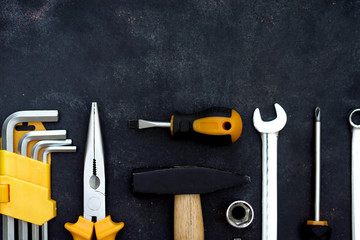 construction tools in wooden box in black background