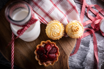 Sweet breakfast. Mini tarts with strawberries and buns with pudding.