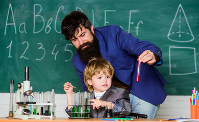 Ready to success. using microscope in lab. Back to school. father and son at school. student doing science experiments with microscope in lab. teacher man with little boy. school lab equipment