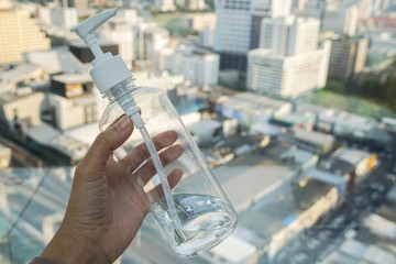 close up people hold alcohol bottle for hand cleaning