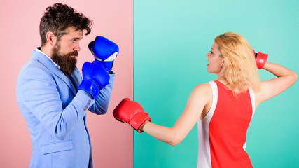 Gender equality. Man formal suit and athletic woman boxing fight. Couple in love competing in...