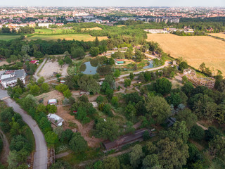 Obraz premium Nature and landscape, municipality of Solaro, Milano: Aerial view of a field, houses and homes, farming, grass green, countryside, farming, trees. Italy