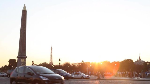 Paris, France - April 5, 2019: Place de la Concorde with Egyptian obelisk and Eiffel tower in background and old lamp posts during sunny summer afternoon with cloudy sky.