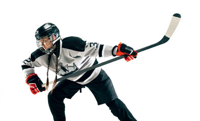 Obraz premium Young female hockey player with the stick isolated on white background. Sportswoman in action wearing equipment attacking for the goal or score. Concept of sport, healthy lifestyle, motion, movement.