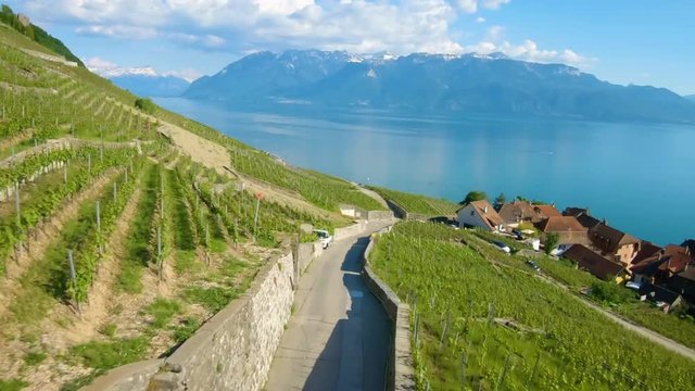 Aerial fast flight down steep road at Lavaux Vineyard in Vaud, Switzerland.
