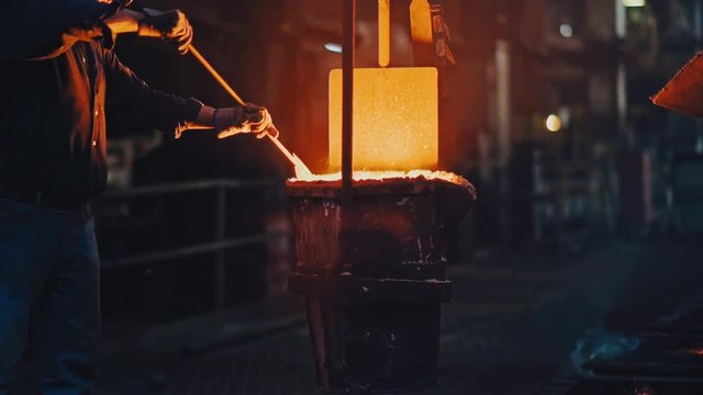 Hard work in the foundry. Molten metal pouring, metallurgy, steel casting foundry