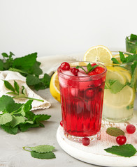 refreshing summer drink of strawberries and cranberries on a white wooden board