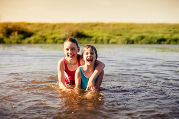 Fototapeta premium Girls bathing in river on summer day.