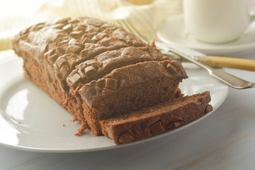 Chocolate pound cake. Homemade dark chocolate pastry for breakfast or dessert, bright background.