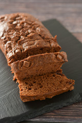 Chocolate cake. Pound cake with chocolate chips, wooden background.
