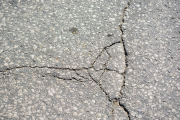 Asphalt texture. Cracked asphalt road surface texture. Crack asphalt background