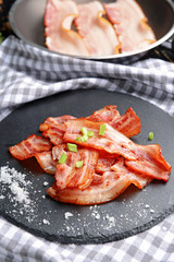 Fried bacon on slate plate
