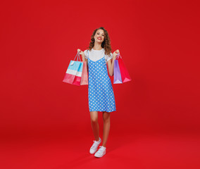 concept of shopping purchases and sales of happy   girl with packages  on red background.