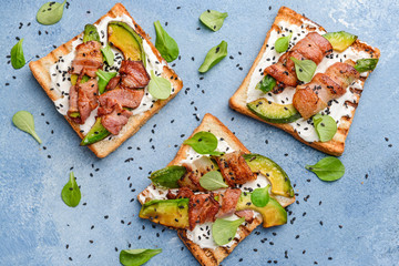 Tasty toasts with bacon on color background