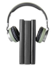 Books and modern headphones on white background. Concept of audiobook
