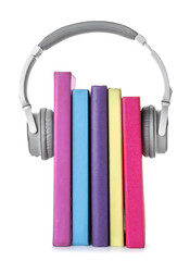 Books and modern headphones on white background. Concept of audiobook