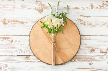 Beautiful bouquet with freesia flowers on wooden table