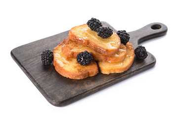 Board with tasty French toasts on white background