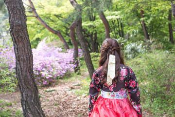 Obraz na płótnie Canvas girl in red dress in garden