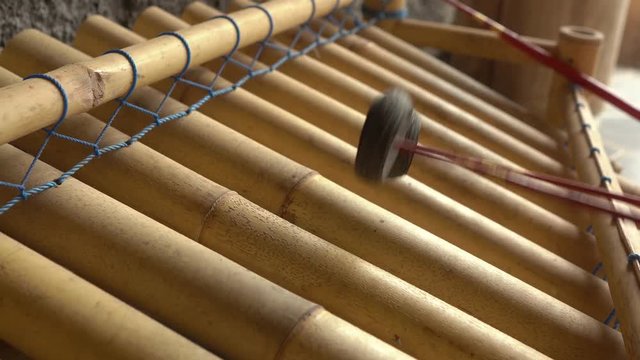 Musician playing Bali musical bamboo instrument Rindik in Bali, Indonesia.