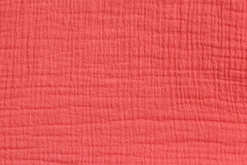  Cotton muslin background in rich coral color. Matt fabric surface pressed. Close-up.