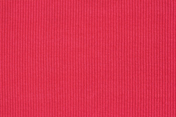 Ribbed textile material, in fine-knit stretch fabric. Knitwear texture. Amaranth color background.
