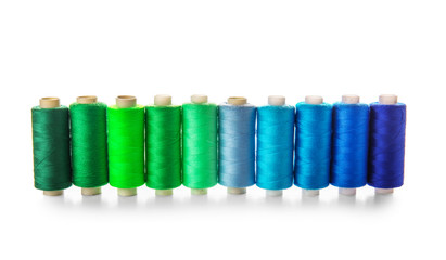 Colorful sewing threads on white background