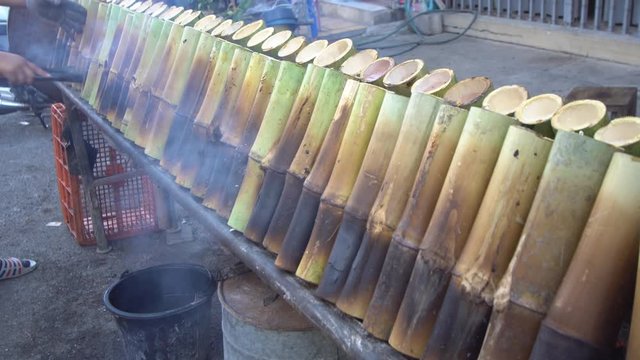 'Khao Lam' Glutinous rice roasted in bamboo joints is burned in a fire with coconut shell fuel.