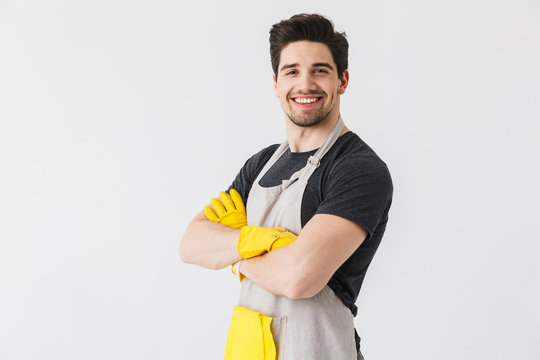 Happy young houseman househusband isolated over white wall background.