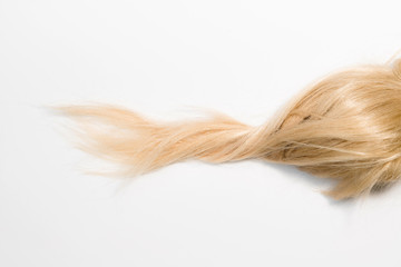 Blond natural hair extensions isolated on white background. Clip