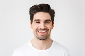 Happy young excited emotional man posing isolated over white wall background.