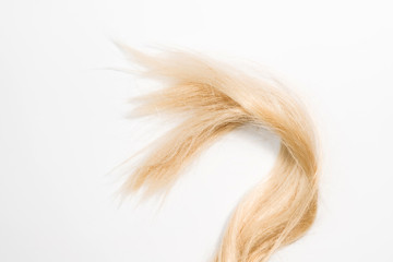 Blond natural hair extensions isolated on white background. Clip